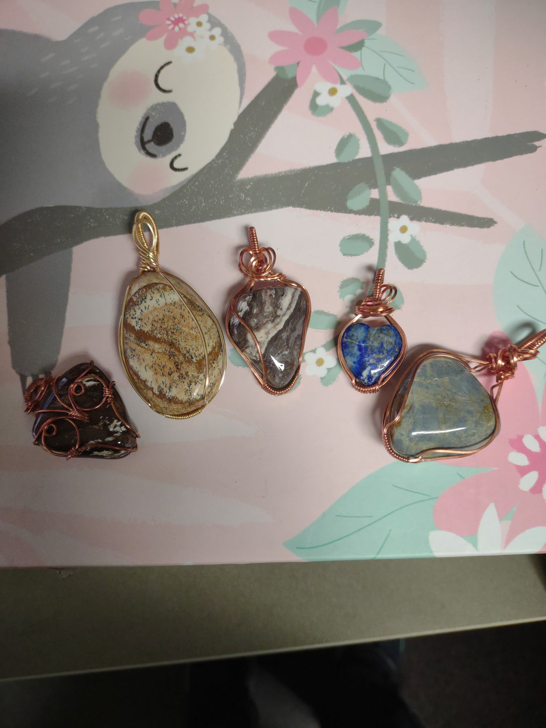 Copper wire hand wrapped tumbled stones from Joy Discovers for Arroyo Grande's art in the park, California's central coast, San Luis Obispo county