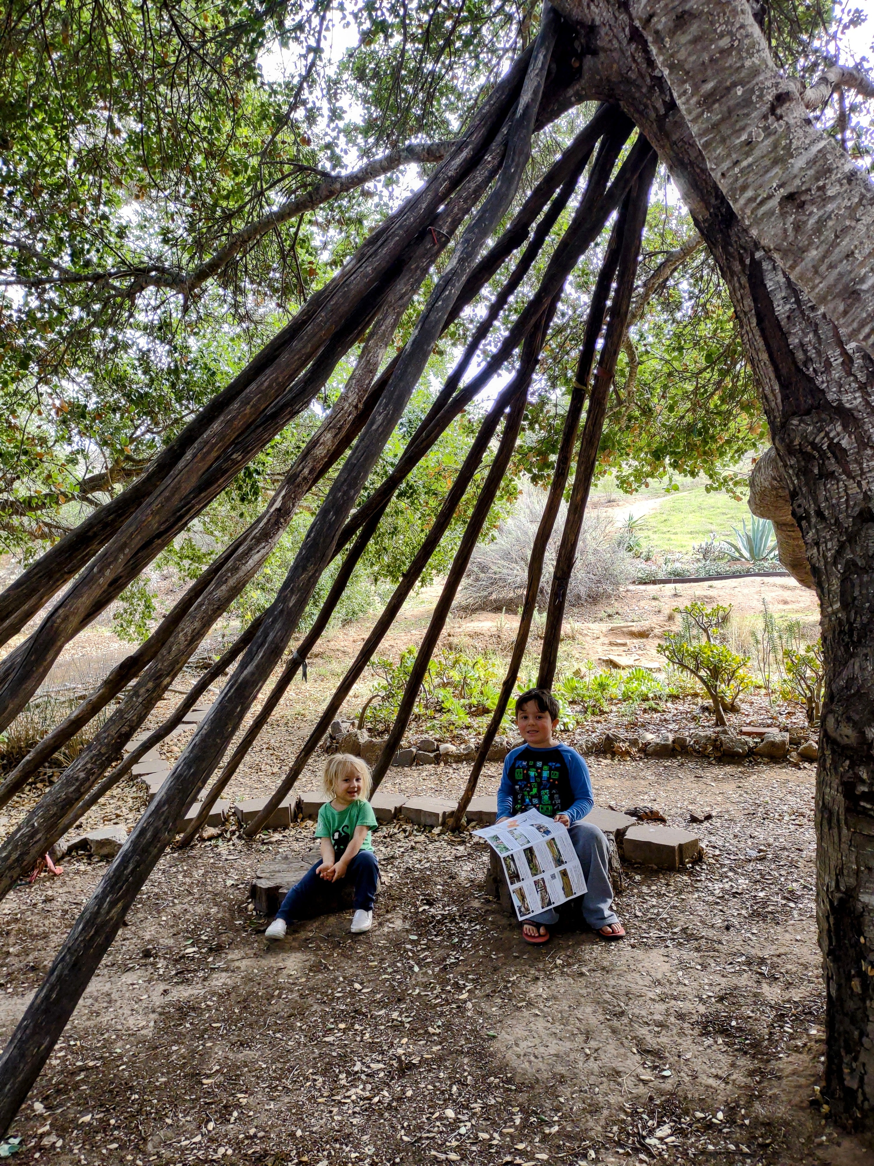 Two kids enjoying a teepee in San Luis Obispo's Botanical Garden